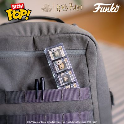 A case of 4 Funko Bitty Pop!s being stored in the front pocket of a backpack