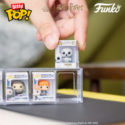 A Bitty Pop! being put in the top of the case